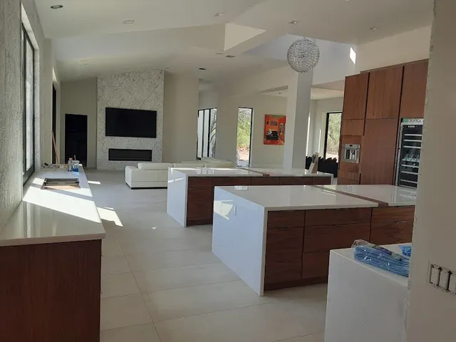 Bright open kitchen and living room with fresh white walls and ceilings in a Phoenix home